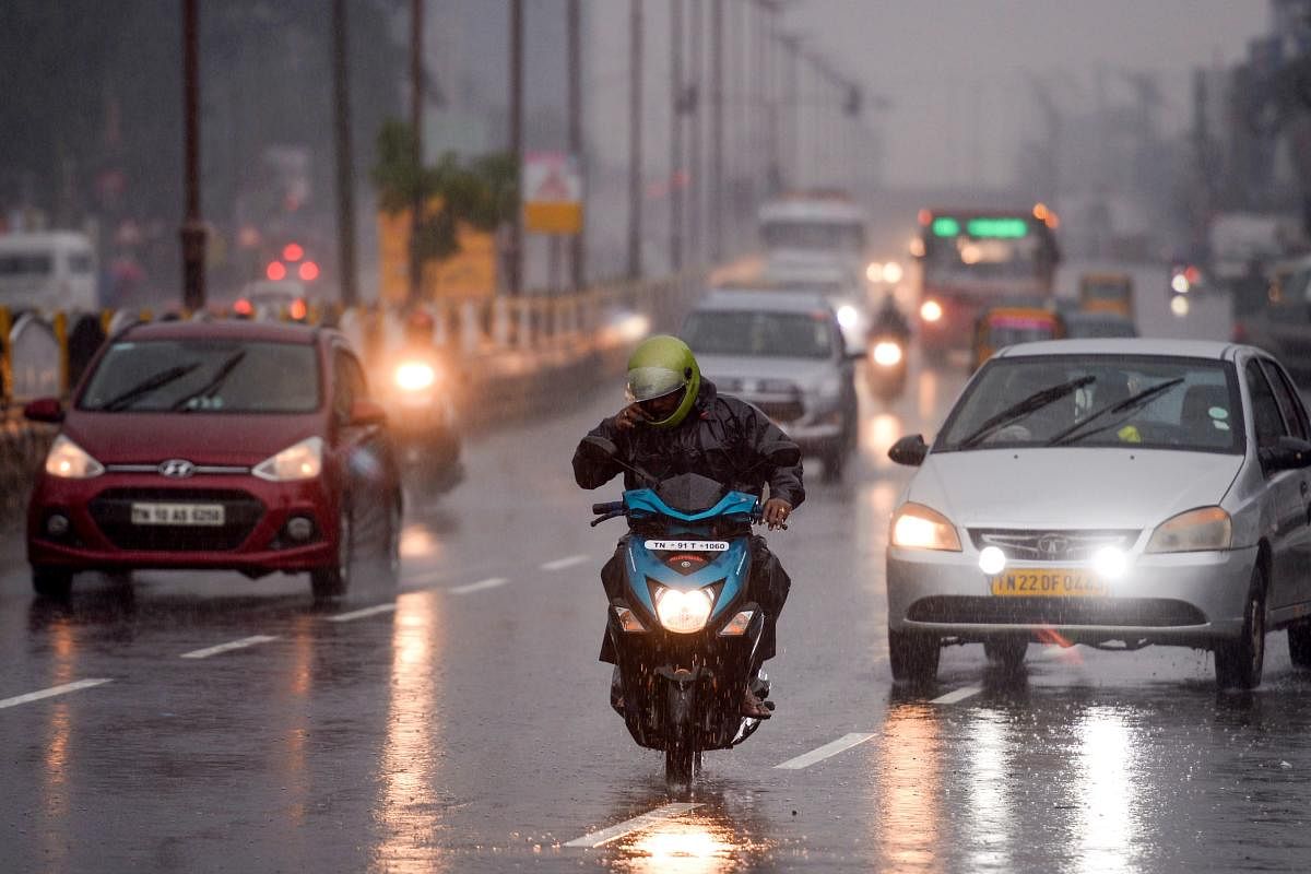 Motorists make their way along a street under heavy rains in Chennai as cyclone Nivar approaches the southeastern coast of the country. Credit: AFP