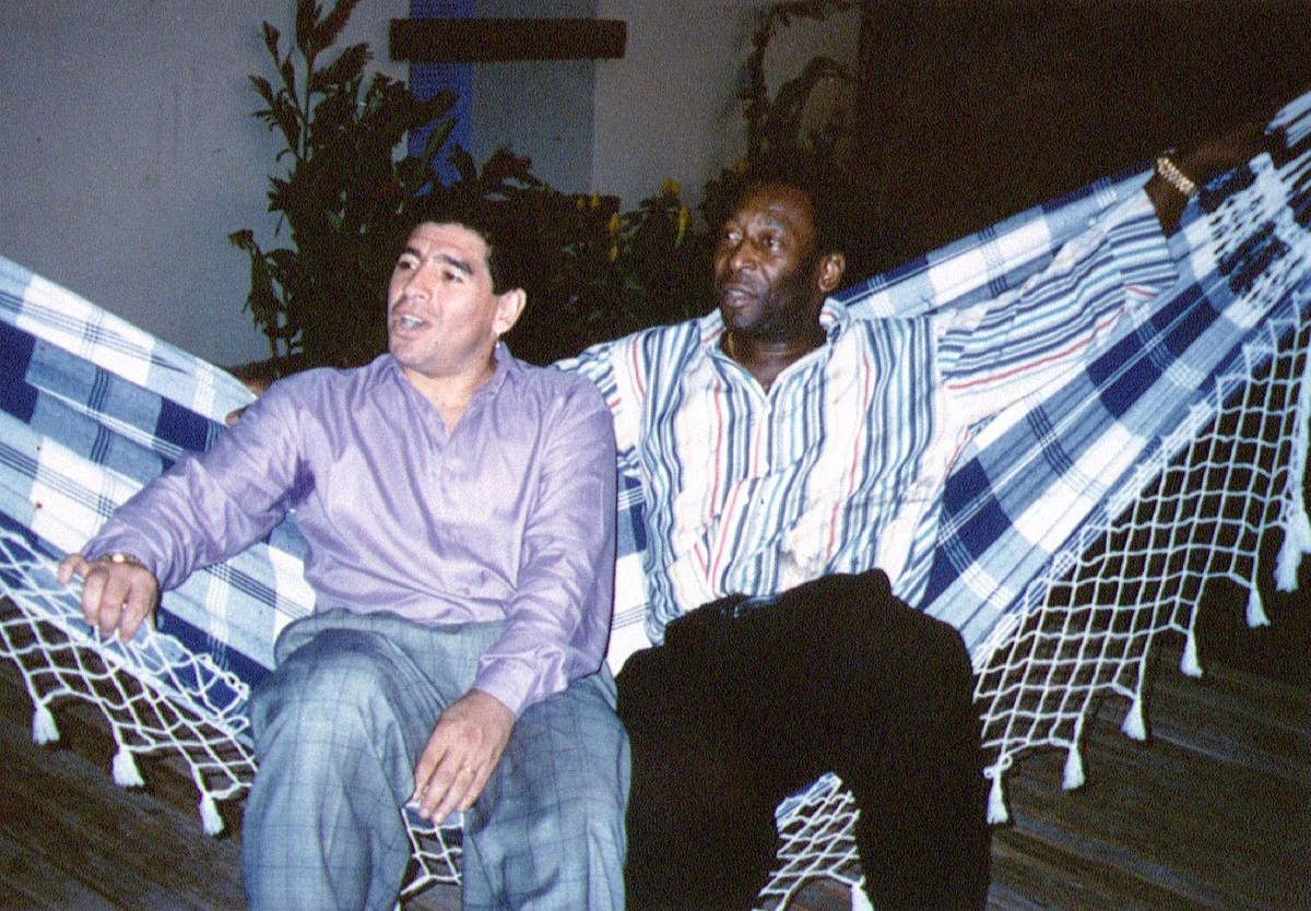 Soccer legends Diego Maradona (L) and Pele rest on a hammock during a reception in Rio de Janeiro. Credit: Reuters file photo.