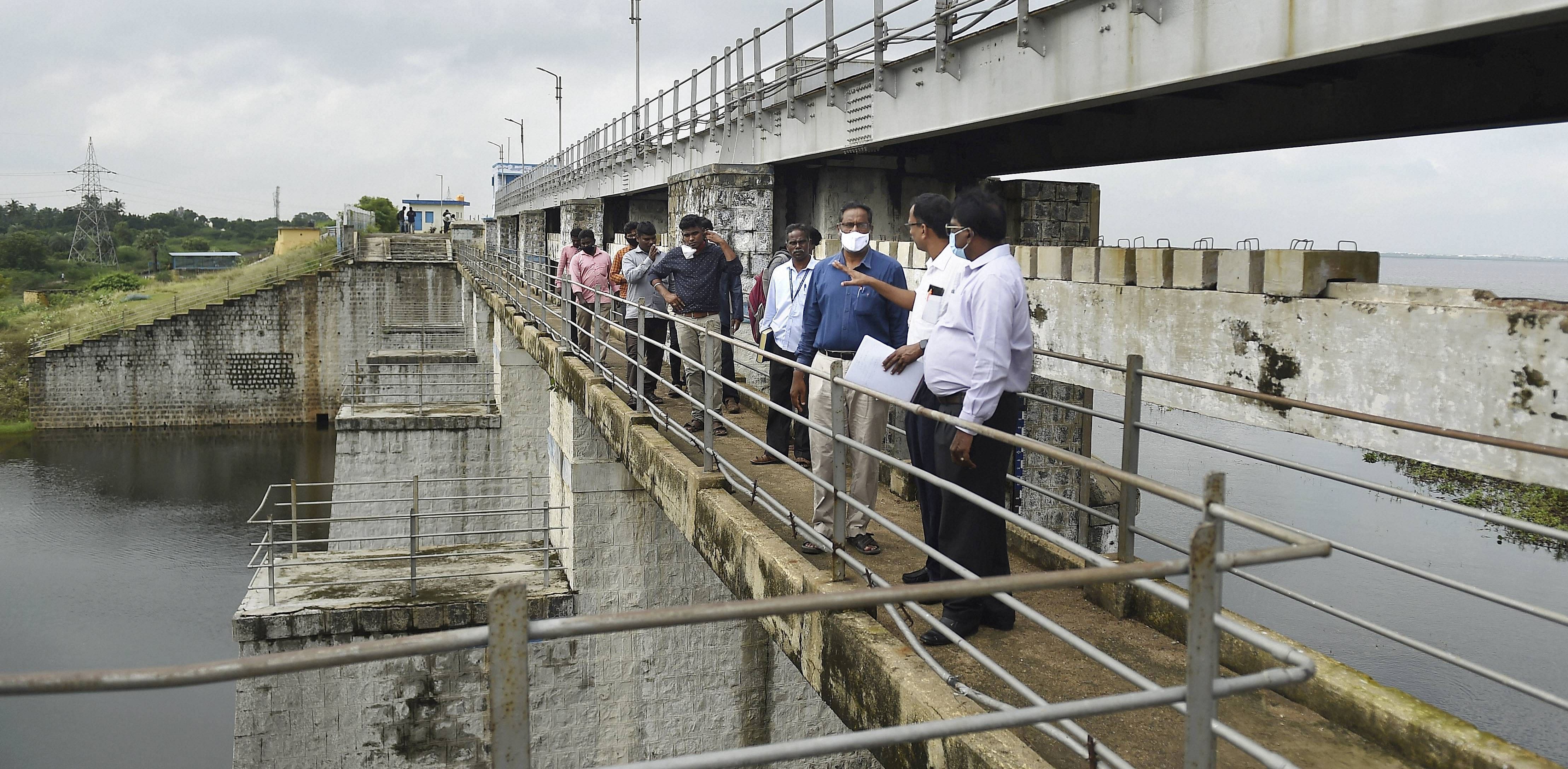 Officials inspect Chembarambakkam lake, after it reached 80% of its capacity. Credit: PTI