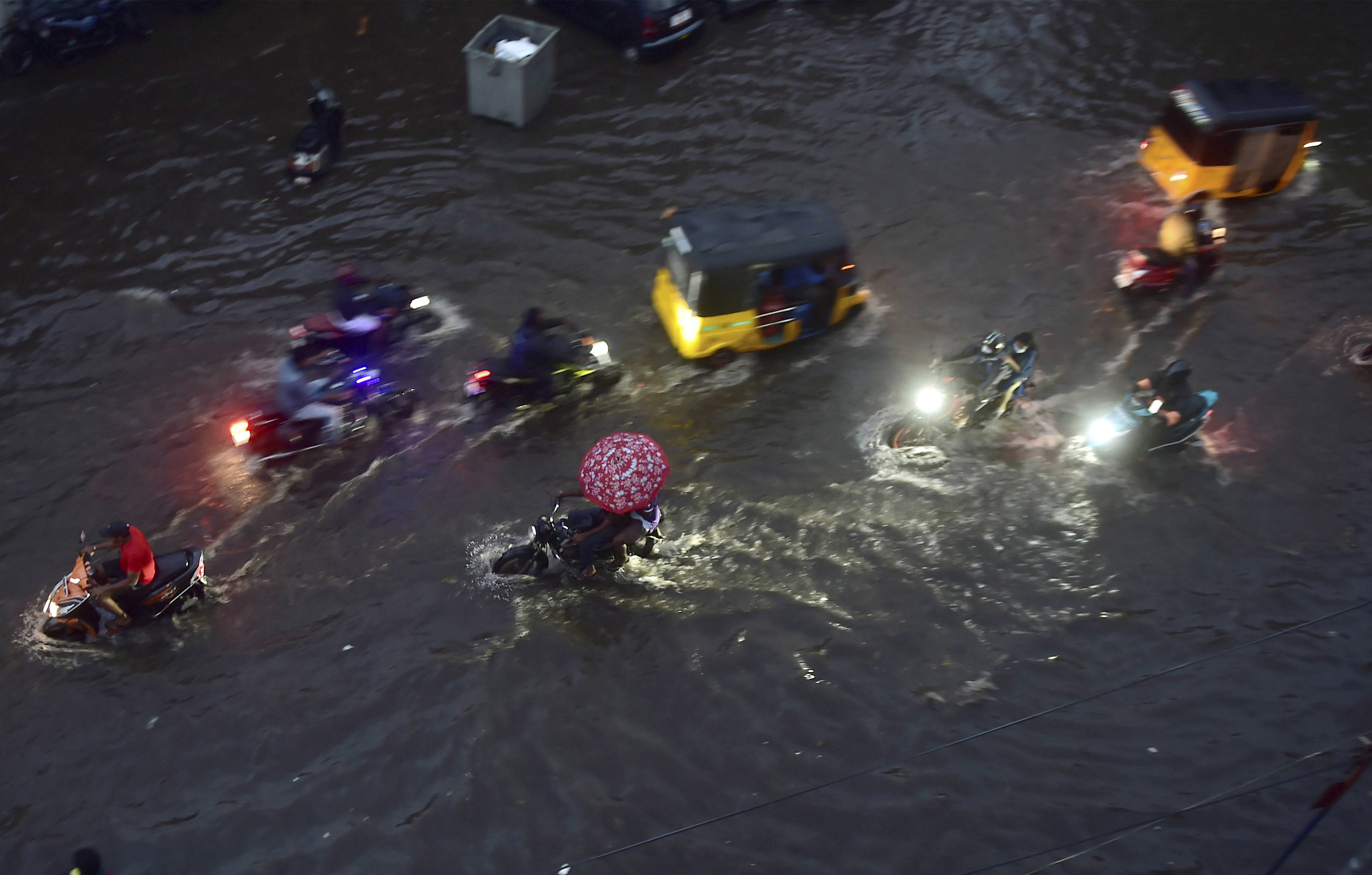   Chennai: Vehicles ply on a waterlogged road during heavy rain triggered by Cyclone Nivar, in Chennai, Tuesday, Nov. 24, 2020. Credit: PTI Photo