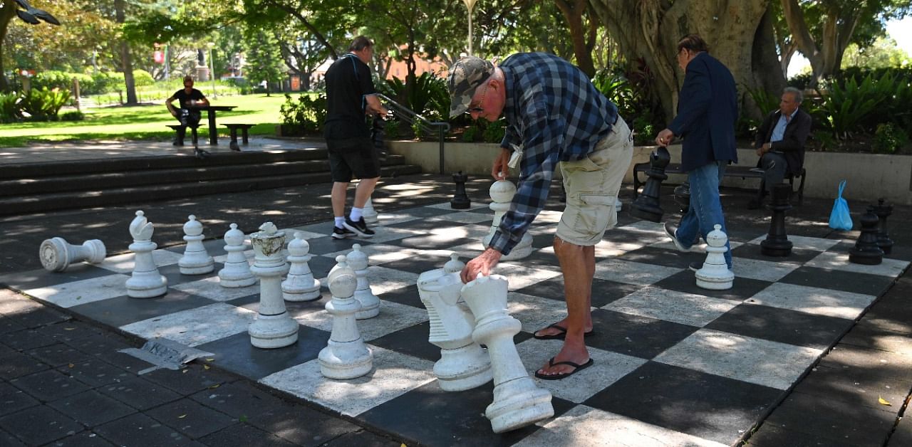 People play chess on a giant chess board at Hyde Park in Sydney on November 26, 2020. Credit: AFP Photo