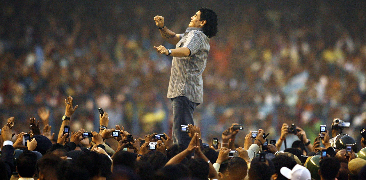 Diego Armando Maradona gestures as he attends a felicitation programme at Salt Lake Stadium in Kolkata in 2008. Credit: AFP Photo