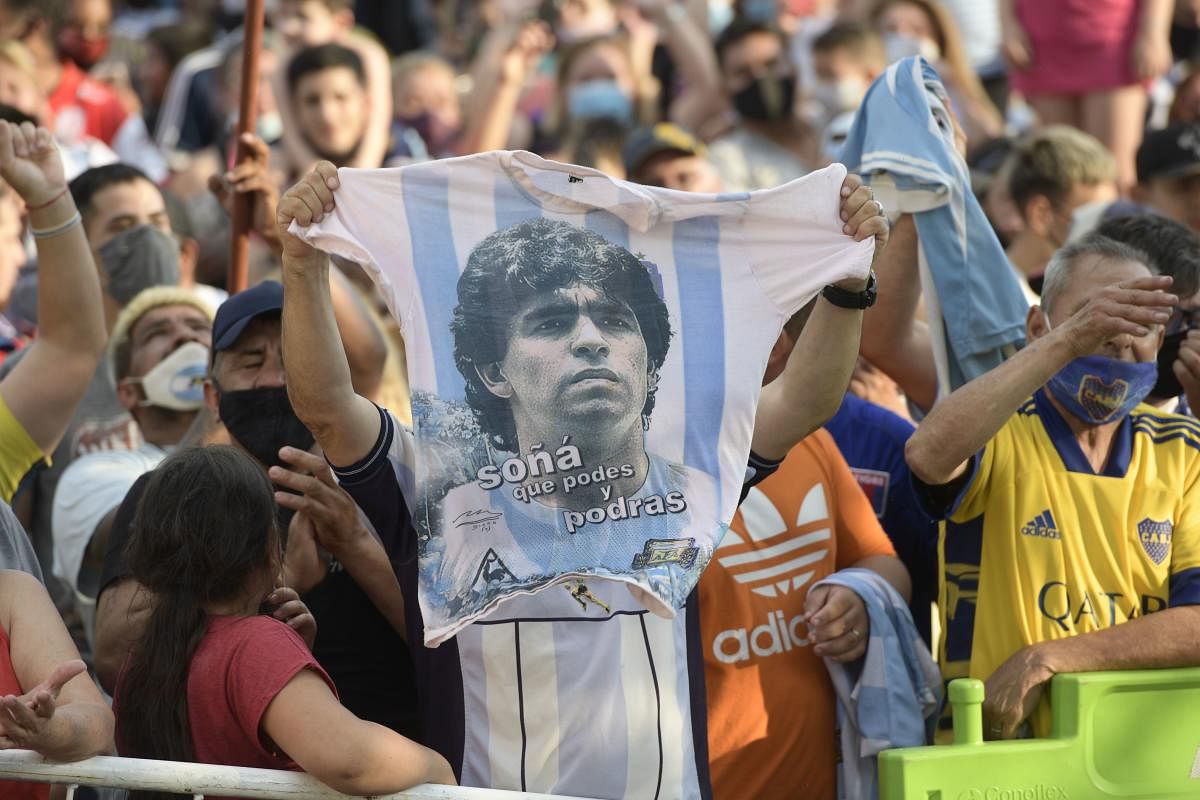 Fans gather outside the morgue where the late Argentine football star Diego Maradona's body will undergo an autopsy. Credit: AFP
