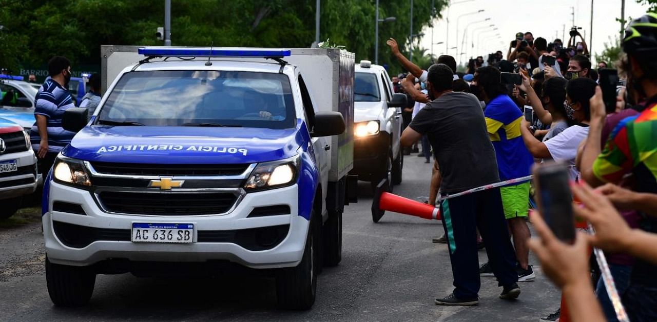 A scientific police van leaves the gated community where Argentine football star Diego Maradona died, carrying his mortal remains, in Benavidez, Buenos Aires. Credit: AFP.