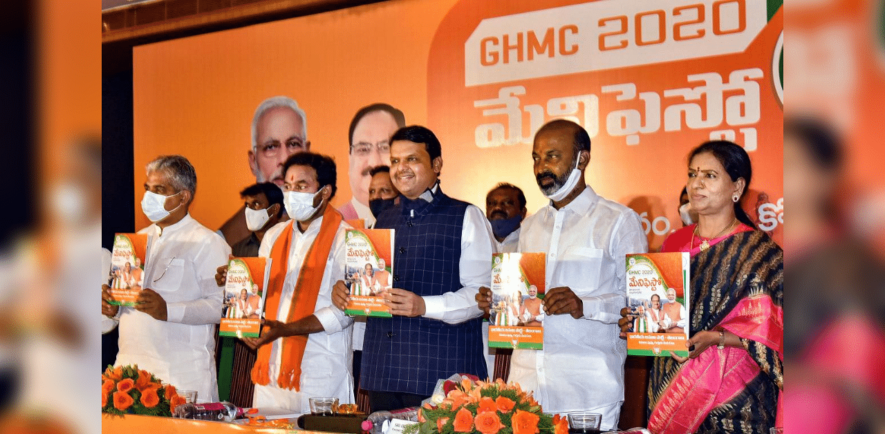 Senior BJP leader Devendra Fadnavis along with party National General Secretary Bhupendra Yadav (R), Telangana BJP Chief Bandi Sanjay Kumar (2L) and State Home Affairs Minister G. Kishan Reddy (2R) releases the party's GHMC manifesto, in Hyderabad, Thursday, Nov. 26, 2020. Credit: PTI Photo