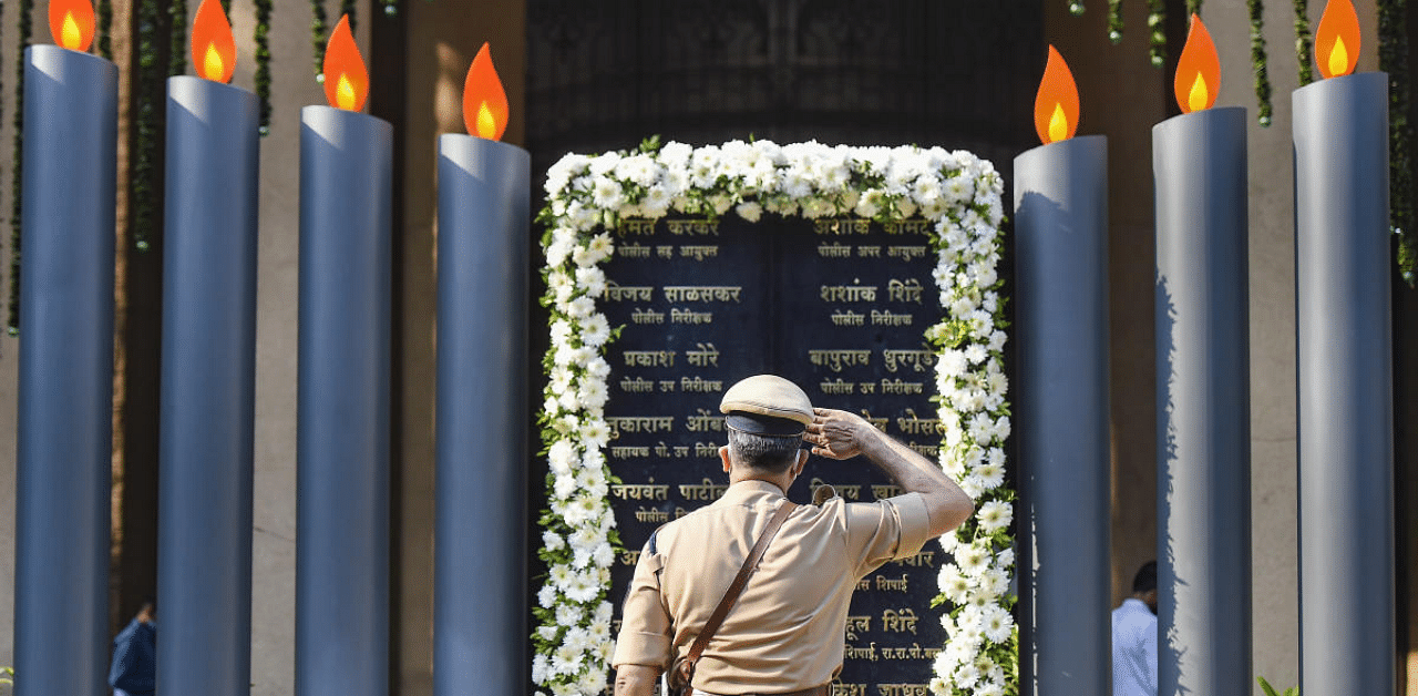 A policeman pays tribute to martyrs at Police Memorial during the 12th anniversary of the 26/11 Mumbai terror attacks, in Mumbai. Credit: PTI Photo