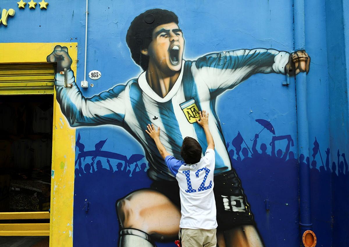 A fan mourns the death of soccer legend Diego Maradona, outside the Alberto J. Armando "La Bombonera" stadium, in Buenos Aires, Argentina. Credit: Reuters.