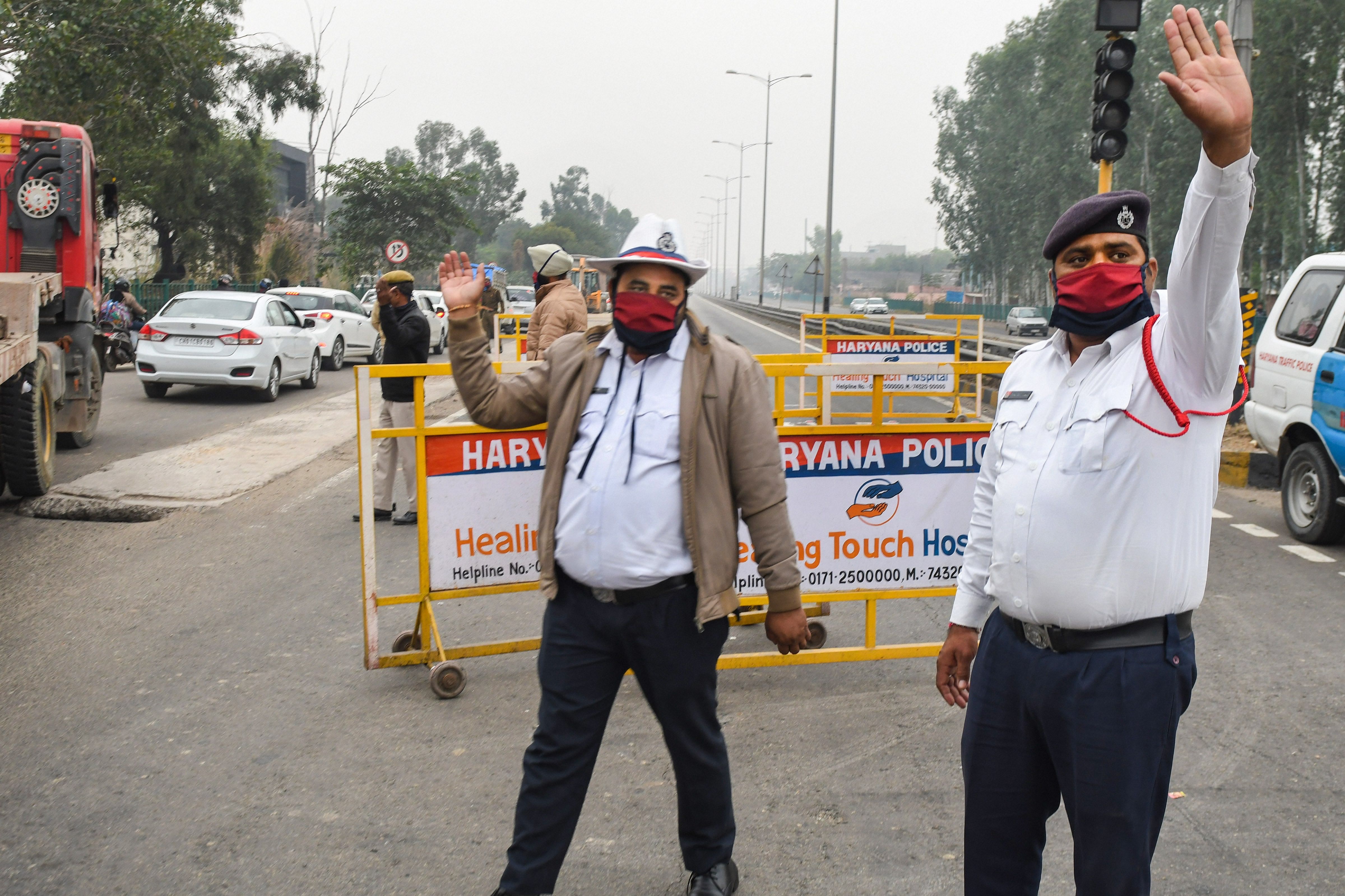 Police divert the traffic on the national highway due to a protest by farmer organisations against the farm reform bills, in Ambala district. Credit: PTI Photo