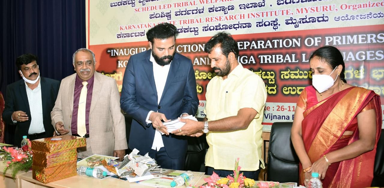 Social Welfare Minister B Sriramulu releases a book during the workshop, jointly organised by Ministry of Tribal Affairs, Scheduled Tribes Welfare department and Karnataka State Tribal Research Institute in Mysuru on Thursday. KSRTI Director T T Basavanagouda, University of Mysore Vice-Chancellor G Hemantha Kumar, MLA L Nagendra and ZP president Parimala Shyam are seen. Credit: DH.