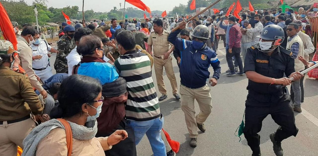 Police personnel baton charge protestors as they block a road during a protest in support of the nationwide strike by ten central trade unions against various policies of the NDA government, in Durgapur district. Credit: PTI.