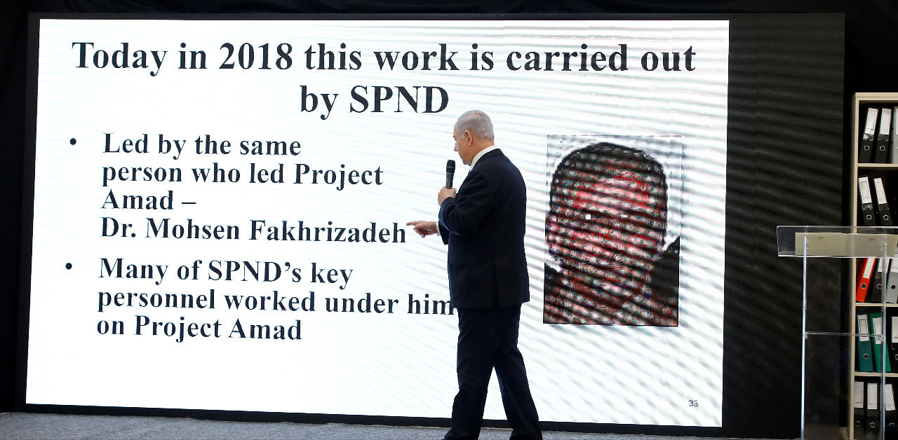 Israeli Prime Minister Benjamin Netanyahu points at a screen with an image of Iranian nuclear scientist Mohsen Fakhrizadeh during a news conference at the Ministry of Defence in Tel Aviv, Israel, April 30, 2018. Credit: Reuters File Photo