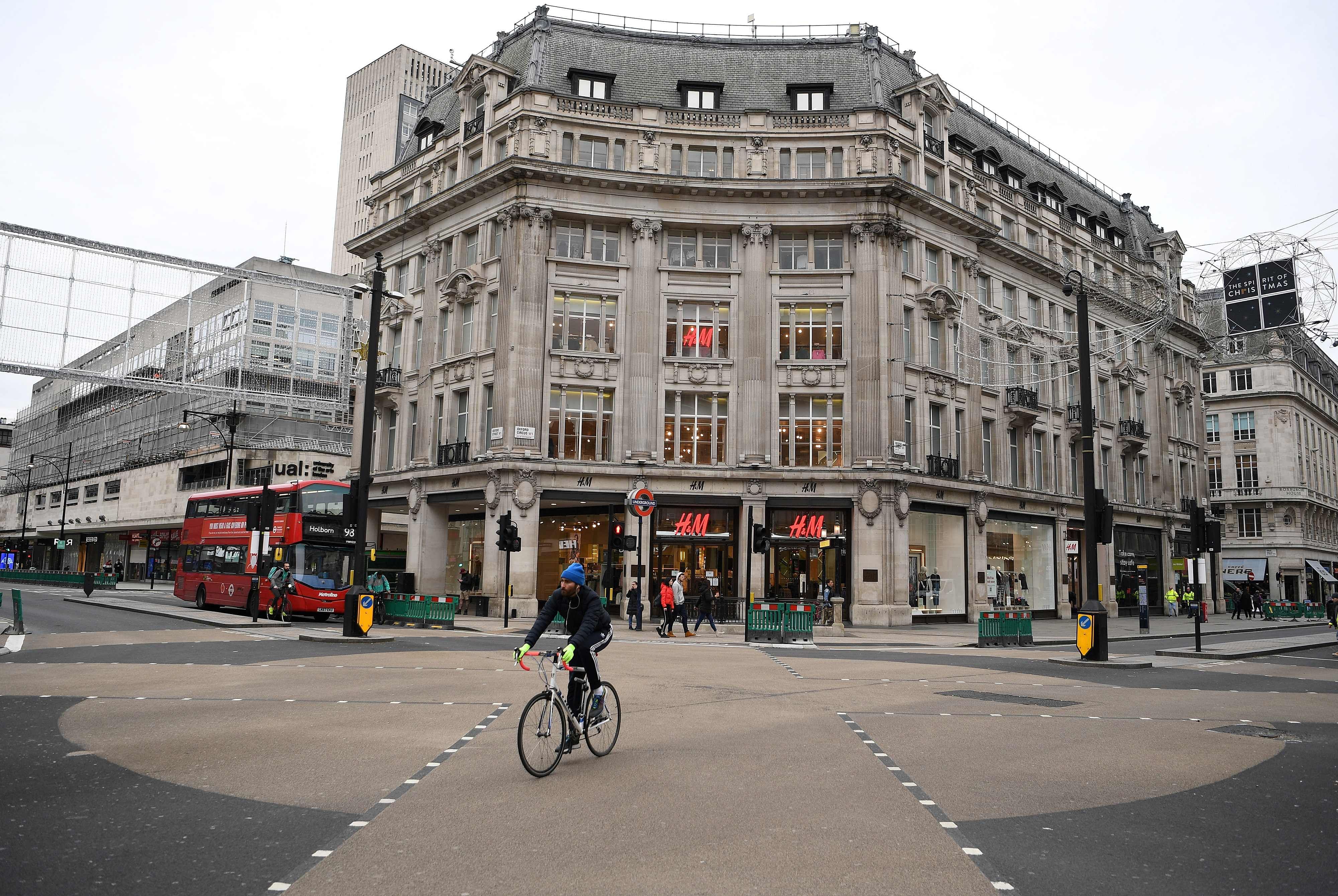 A cyclist rides across an almost deserted Oxford Circus on Oxford Street. Credit: AFP Photo