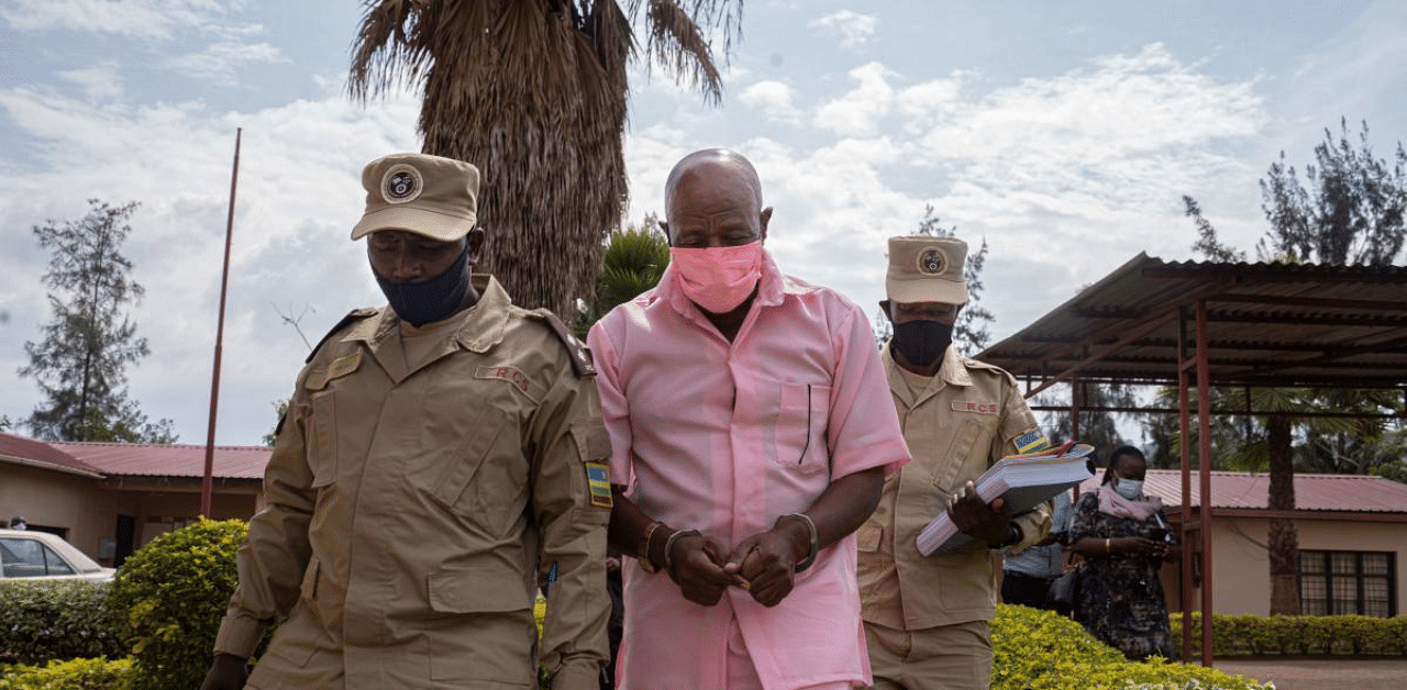 "Hotel Rwanda" hero Paul Rusesabagina (C) in the pink inmate's uniform arriving at Nyarugenge Court of Justice in Kigali, Rwanda. Credit: AFP Photo