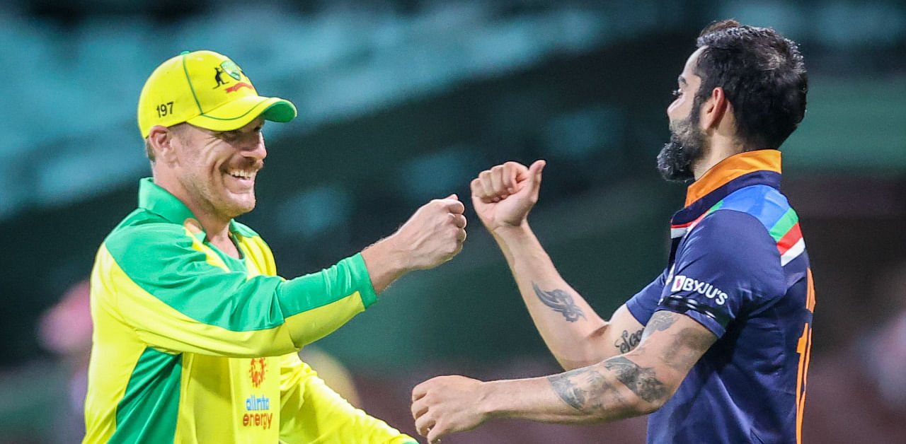Australia's captain Aaron Finch (L) bumps fists with India's captain Virat Kohli after victory during the one-day international cricket match at the Sydney Cricket Ground. Credit: AFP Photo