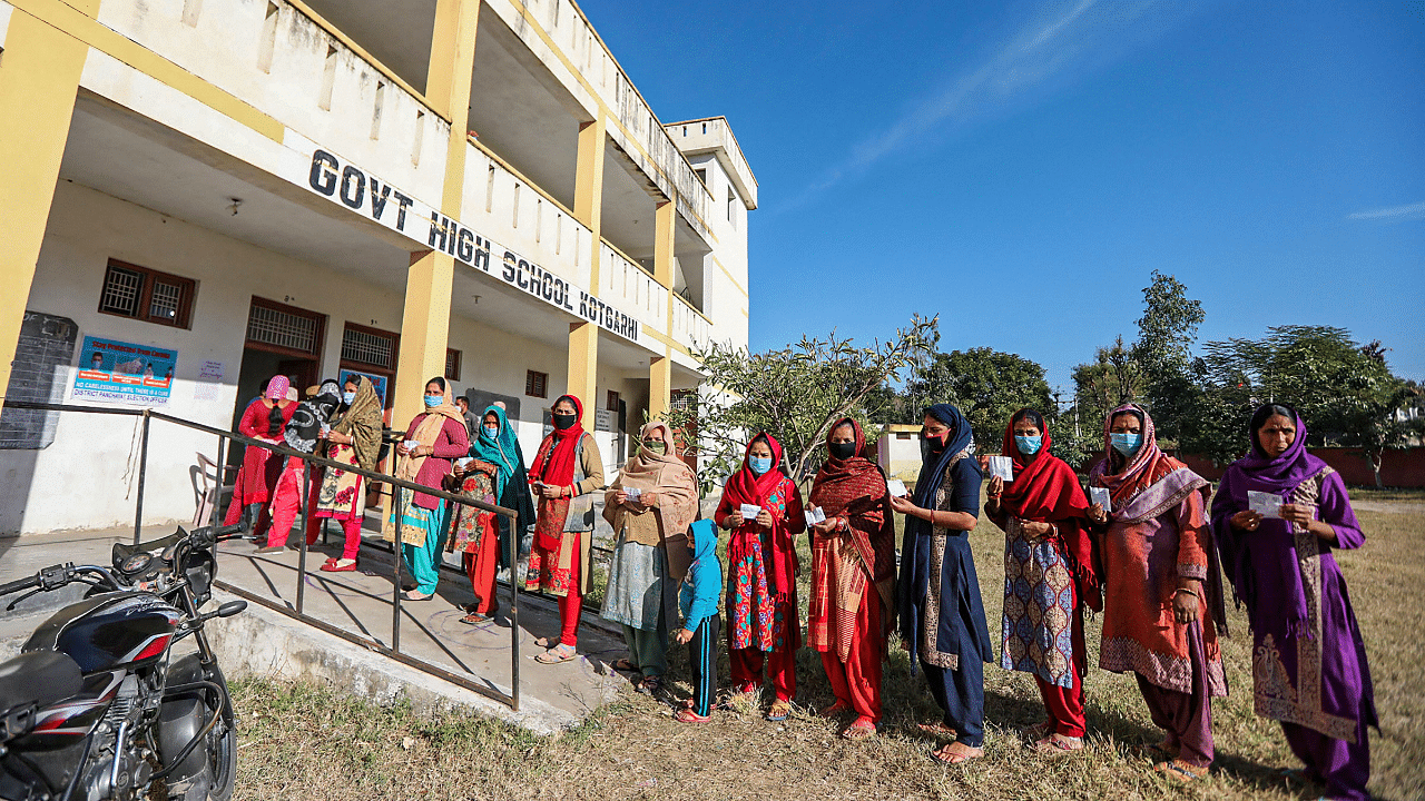 West Pakistani refugees stand in a queue as they wait to cast their votes for the District Development Council elections, at a polling station in Akhnoor of Jammu district. Credit: PTI Photo