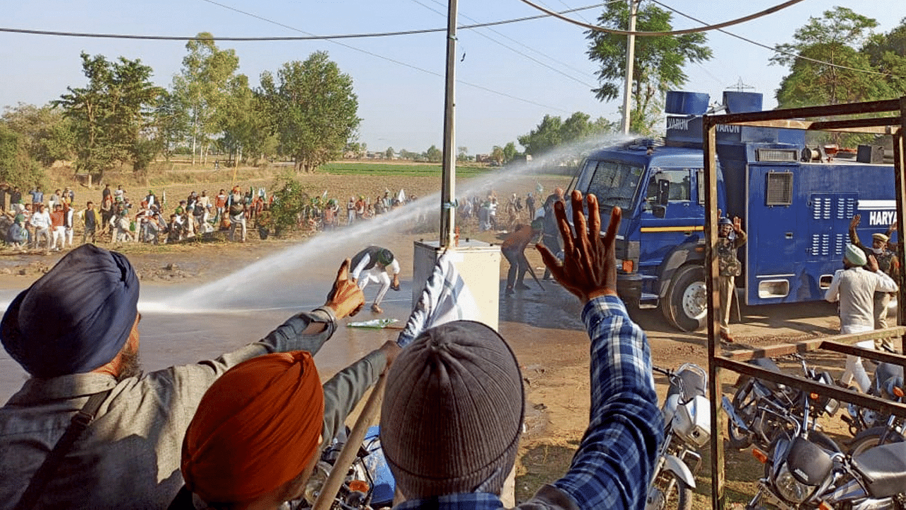 Police deploy water cannons during a clash with various members of farmer organisations, as they marched towards Delhi protesting against the farm reform laws. Credit: PTI Photo