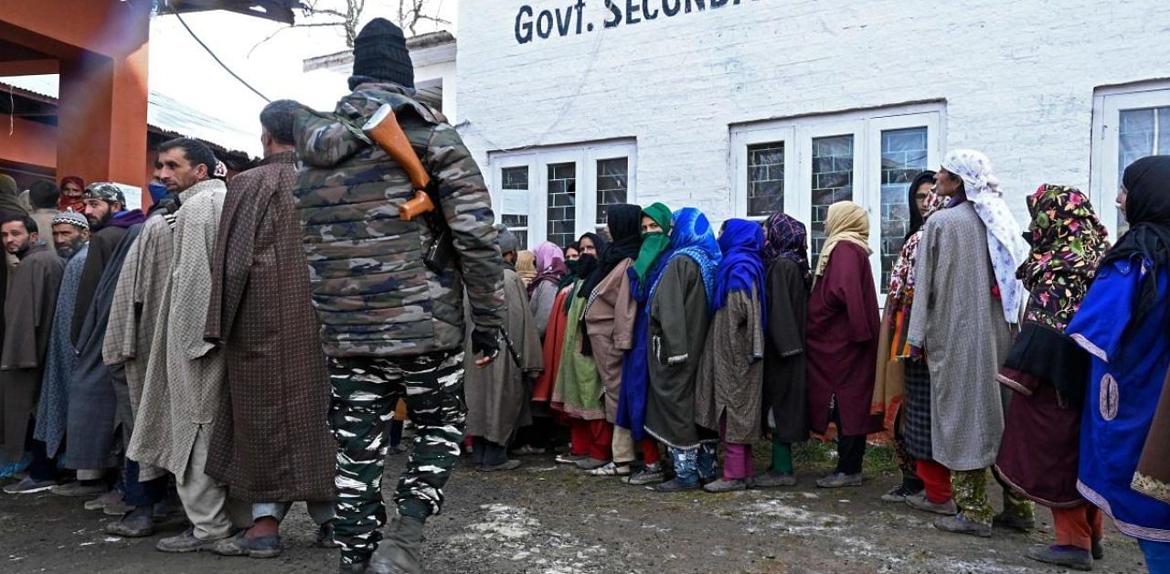 Voters stand in queues to cast their ballots during the first phase of the District Development Council (DDC) and Panchayat by-elections at a polling station in Raiyar-ICH Khansahib village in Budgam district. Credit: AFP