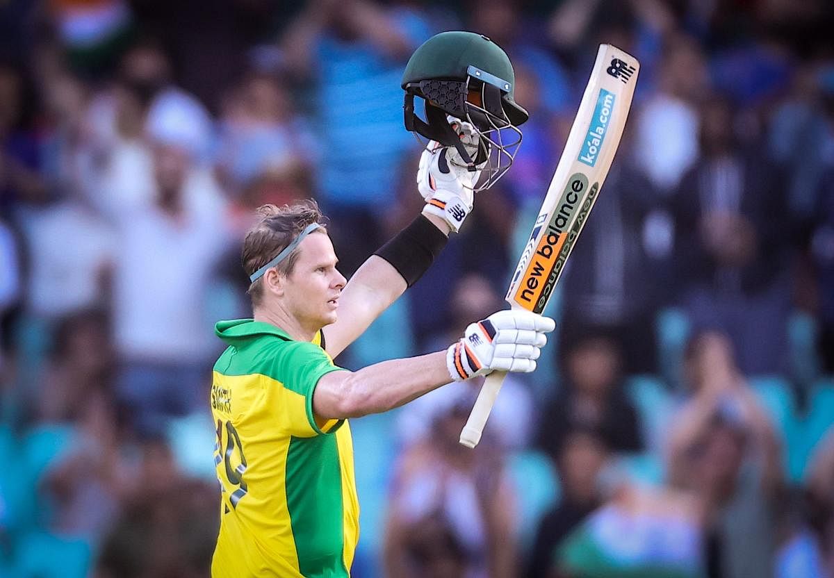 Australia’s Steve Smith celebrates reaching his century during the one-day international cricket match against India at the Sydney Cricket Ground (SCG) in Sydney. Credit: AFP