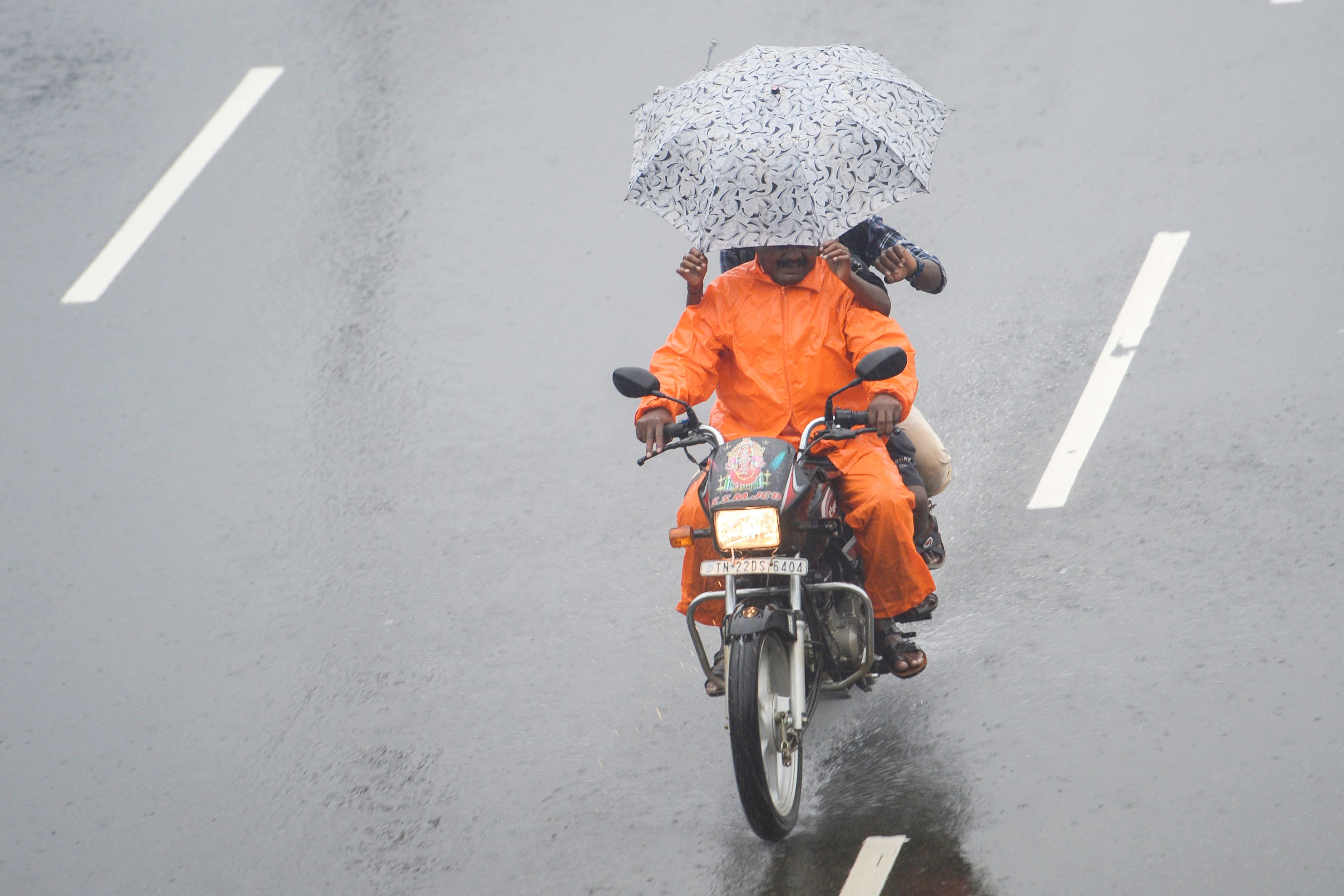 A motorist rides along a street under heavy rains in Chennai as cyclone Nivar approaches the southeastern coast of the country on November 25, 2020. Credit: AFP Photo