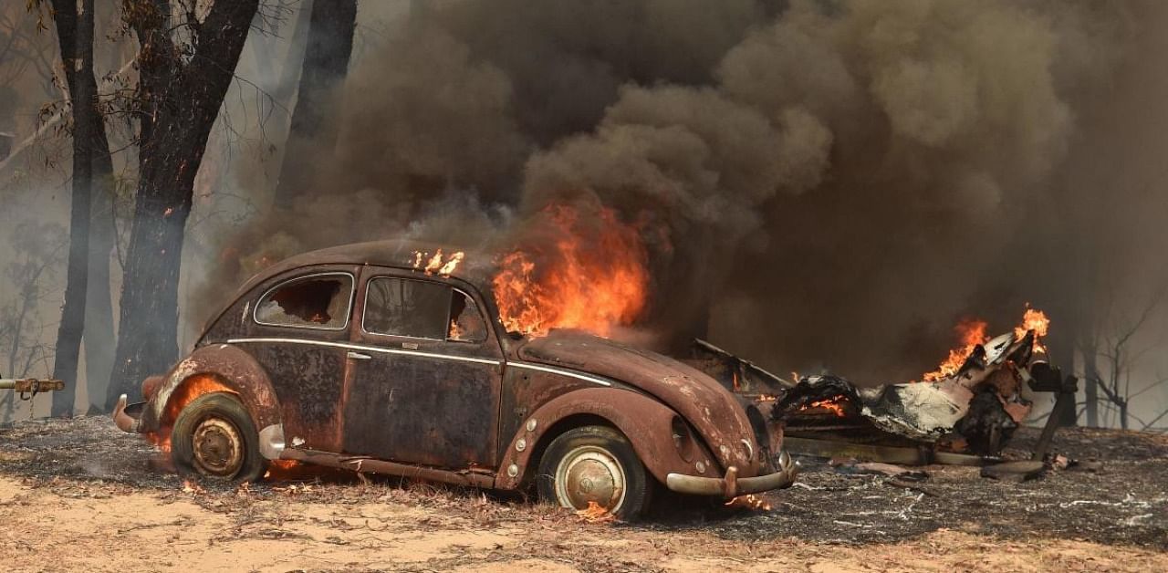 An old car burns from bushfires in Balmoral, 150 kilometres southwest of Sydney on December 19, 2019. Credit: AFP file photo.