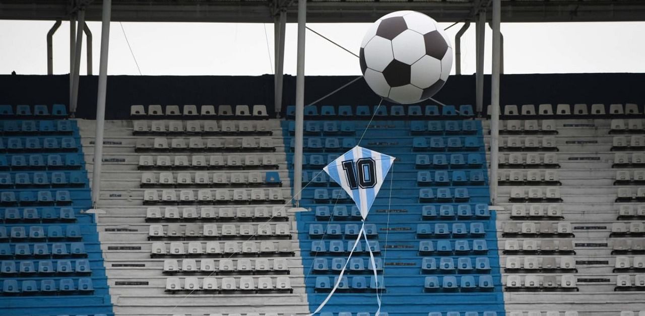A helium balloon with the shape of a soccer and a kite with the Argentine colours and the number 10. Credit: AFP Photo