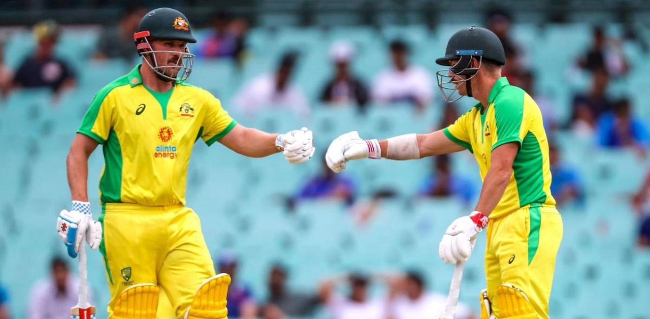 Australia's captain Aaron Finch reacts with teammate David Warner. Credit: AFP Photo