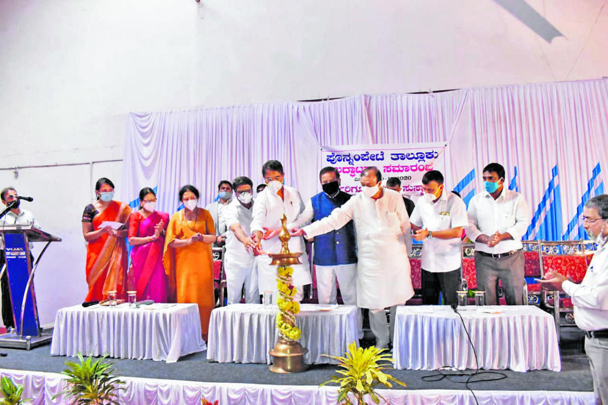 Revenue Minister R Ashoka and others light the lamp to mark the inauguration of Ponnampet taluk.