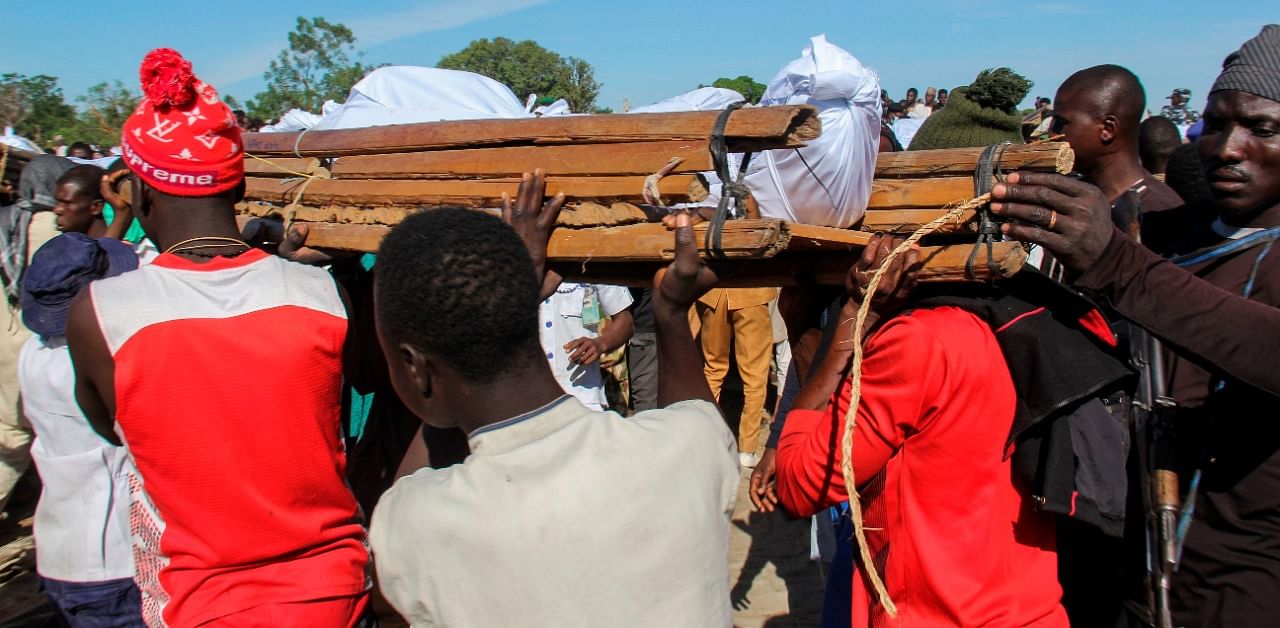 Mourners attend the funeral of 43 farm workers in Zabarmari, about 20km from Maiduguri, Nigeria, on November 29, 2020 after they were killed by Boko Haram fighters in rice fields near the village of Koshobe on November 28, 2020. Credit: AFP Photo