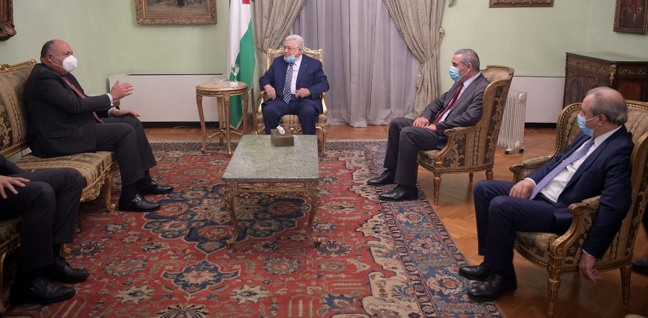 A handout picture provided by the Palestinian Authority's press office (PPO) on November 29, 2020 shows Palestinian president Mamhud Abbas (C) meeting with Egypt's Foreign Minister Sameh Shoukry (L) in Cairo. Credit: AFP Photo