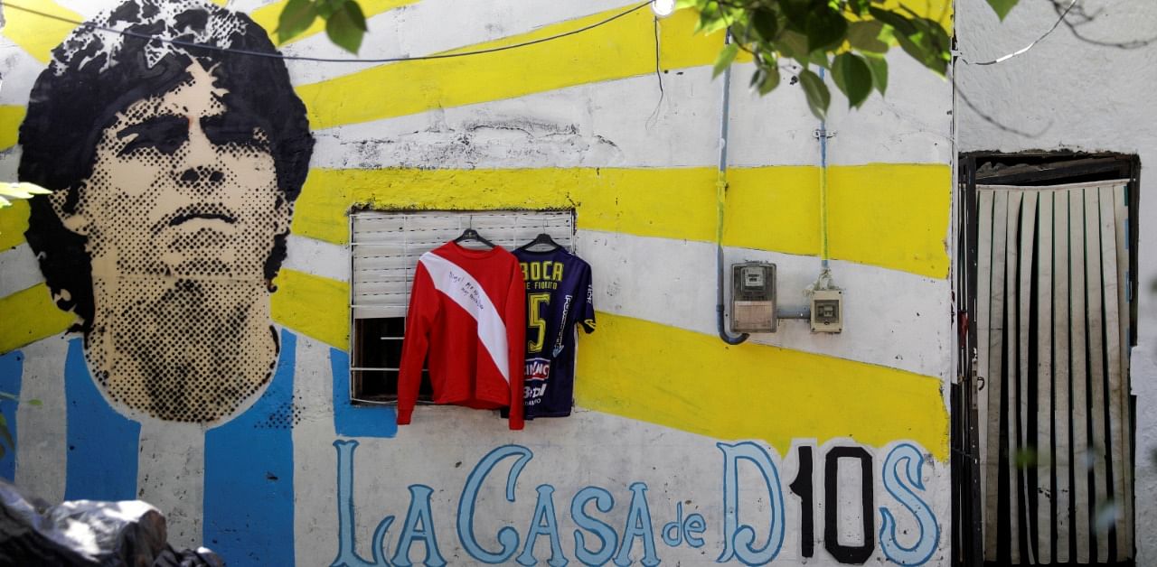 A graffiti of soccer legend Diego Armando Maradona is seen outside the house where he spent his childhood, in Villa Fiorito. Credit: Reuters Photo