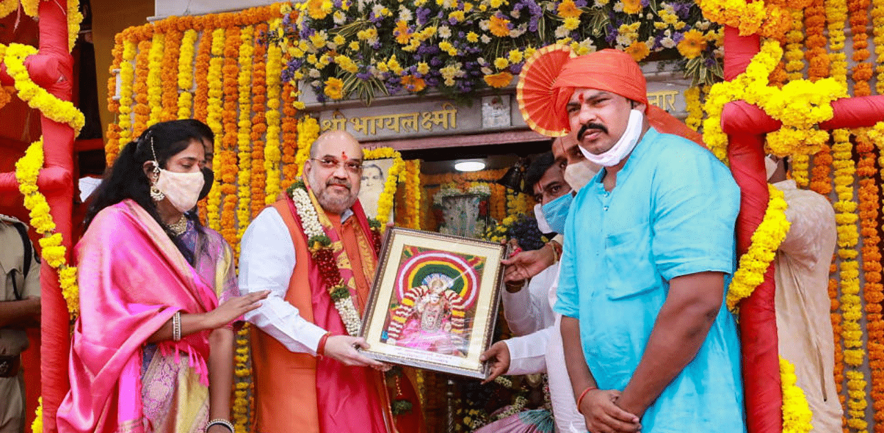 Home Minister Amit Shah being presented with a memento during his visit to Bhagyalakshmi Ammavari Temple, in Hyderabad.  Credit: PTI Photo