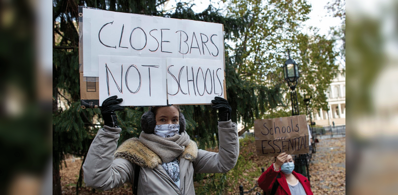  In this file photo parents protest demanding that public schools remain open, outside New York's City Hall on November 19, 2020.  Credit: AFP File Photo