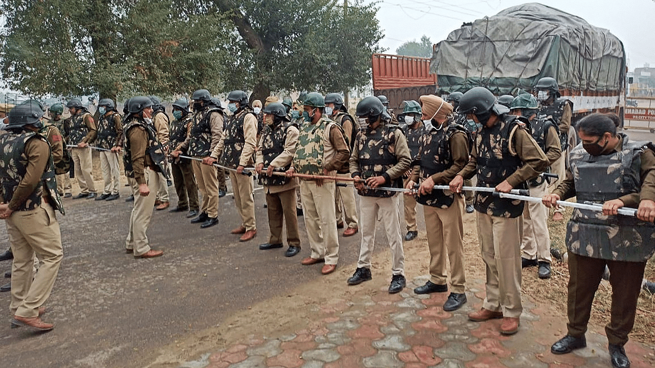 Police make a human barricade to stop various farmer organisations during a protest march against the farm reform bills, in Hisar district. Credit: PTI Photo