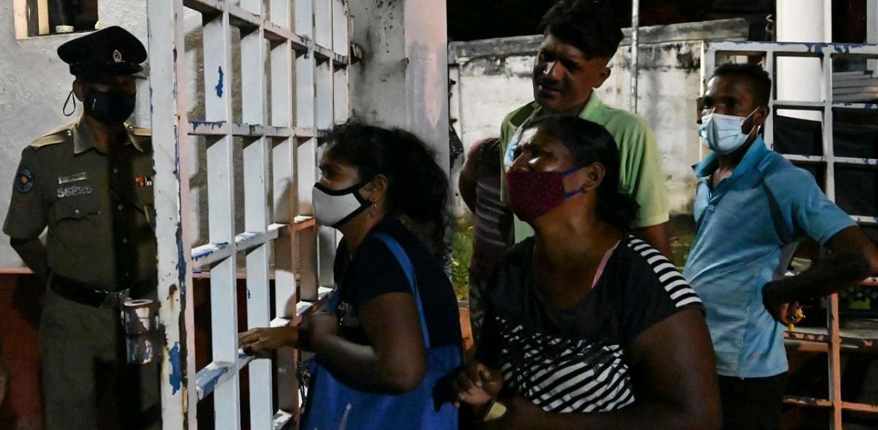 Relatives of inmates weep at Ragama hospital on the outskirts of Colombo on November 30, 2020 a day after a prison riot over the surge of coronavirus infections. Credit: AFP.