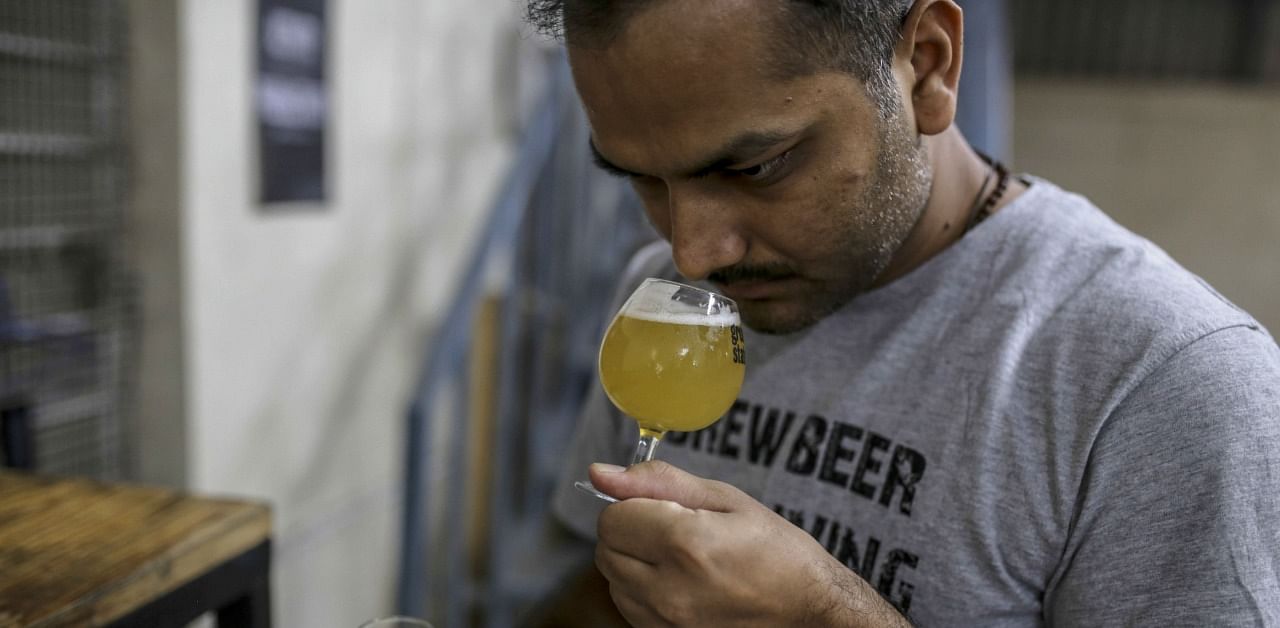 A brewer tests beer at the Great State Ale Works craft brewery in Pune, on Nov. 27. Credit: Bloomberg.