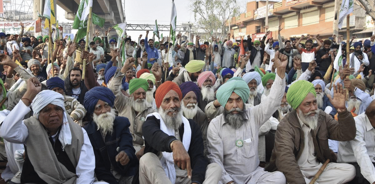 Farmers stage a protest at Tikri border during their ongoing 'Delhi Chalo' agitation against Centre's new farm laws, in New Delhi. Credit: PTI Photo