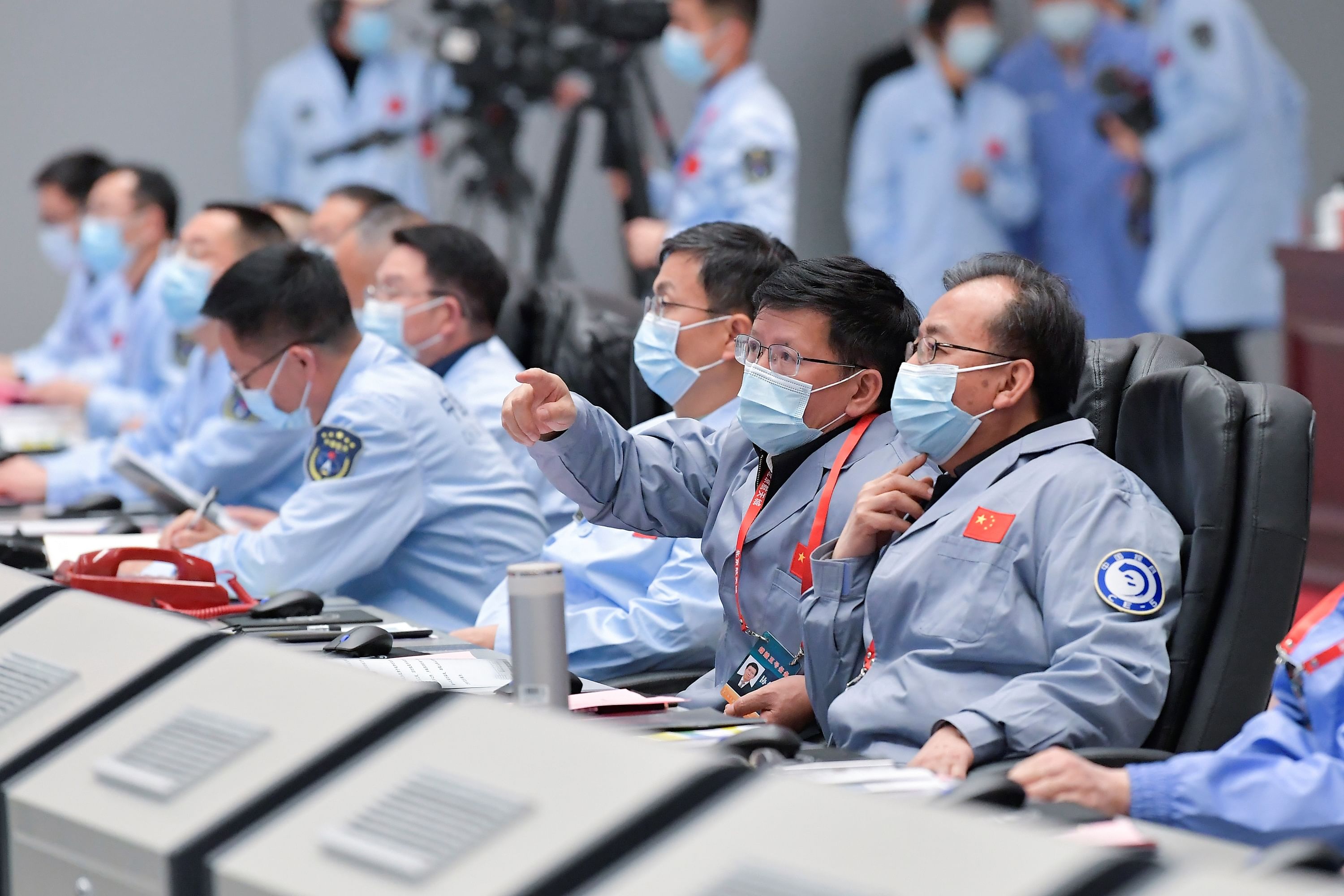Technical personnel monitoring the process during the Chang'e-5 lunar probe landing on the moon. Credit: AFP Photo