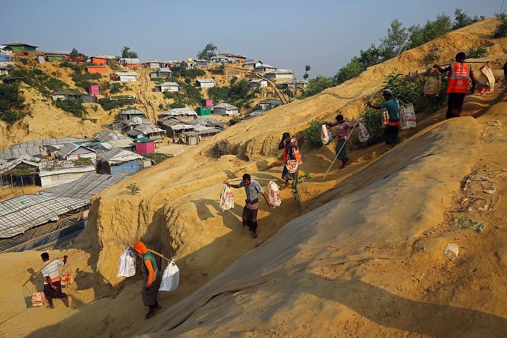 Rohingya refugees carry bricks to a construction site at the Balukhali camp in Cox's Bazar, Bangladesh. Credit: Reuters Photo