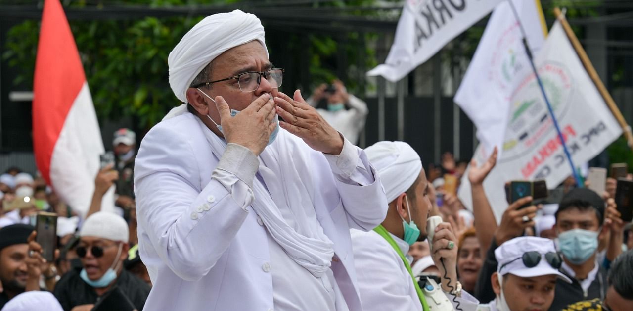 Rizieq Shihab, leader of the Indonesian hardline organisation FPI (Front Pembela Islam or Islamic Defenders Front), greets supporters at their headquarters in Jakarta. Credit: AFP Photo