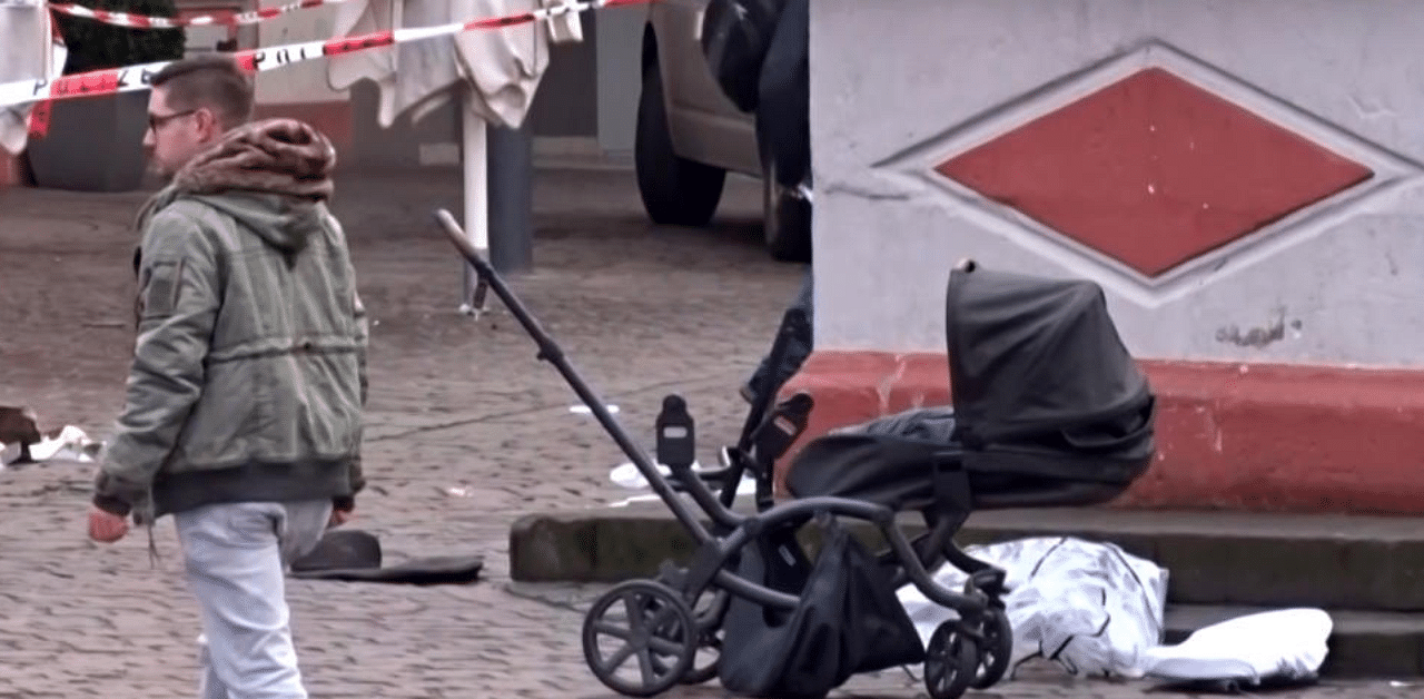 This image grab taken from a video obtained from Steil-TV shows a cordoned off area with a destroyed pram at one of the scenes where a car drove into pedestrians the center of Trier, southwestern Germany, on December 1, 2020.  Credit: AFP 