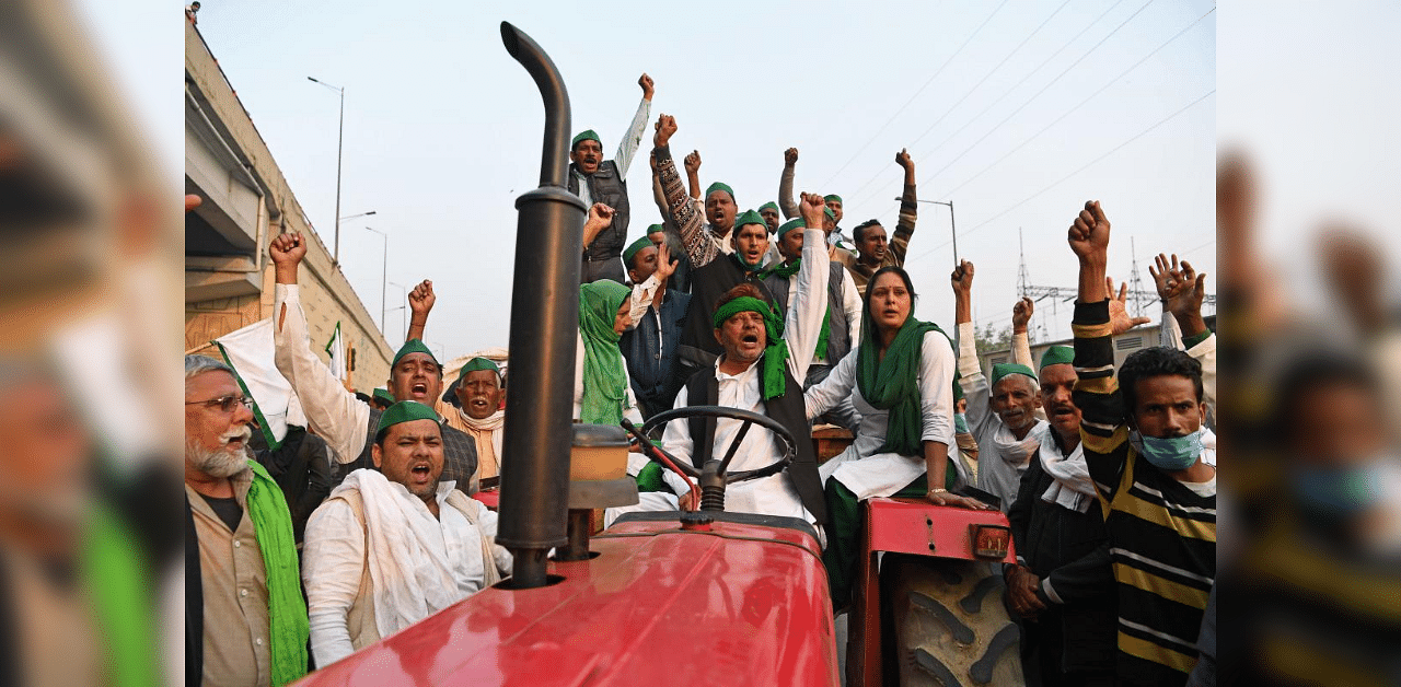 Farmers on a tractor trolley shout slogans near a police road block stopping them from marching to New Delhi to protest against the central government's recent agricultural reforms at the Delhi-Uttar Pradesh state border in Ghazipur on December 1, 2020. Credit: AFP photo