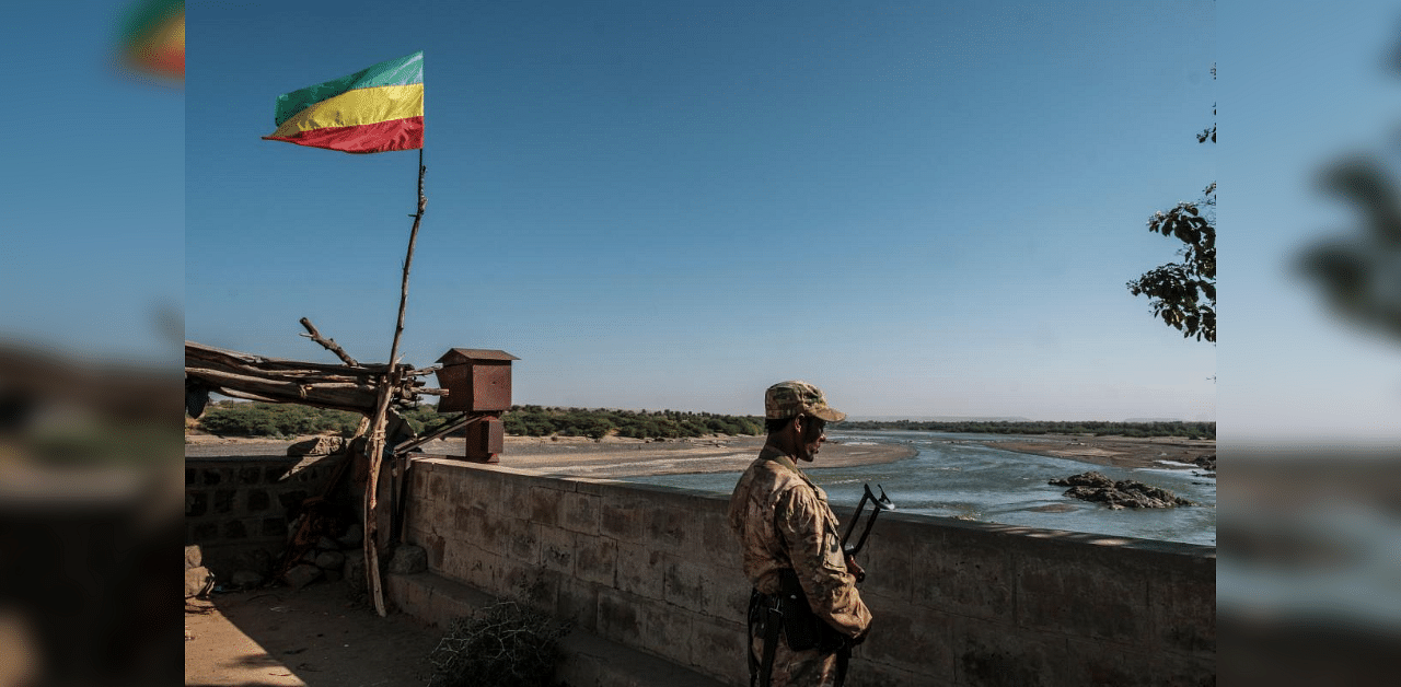 A member of the Amhara Special Forces watches on at the border crossing with Eritrea where an Imperial Ethiopian flag waves, in Humera, Ethiopia, on November 22, 2020.  Credit: AFP photo