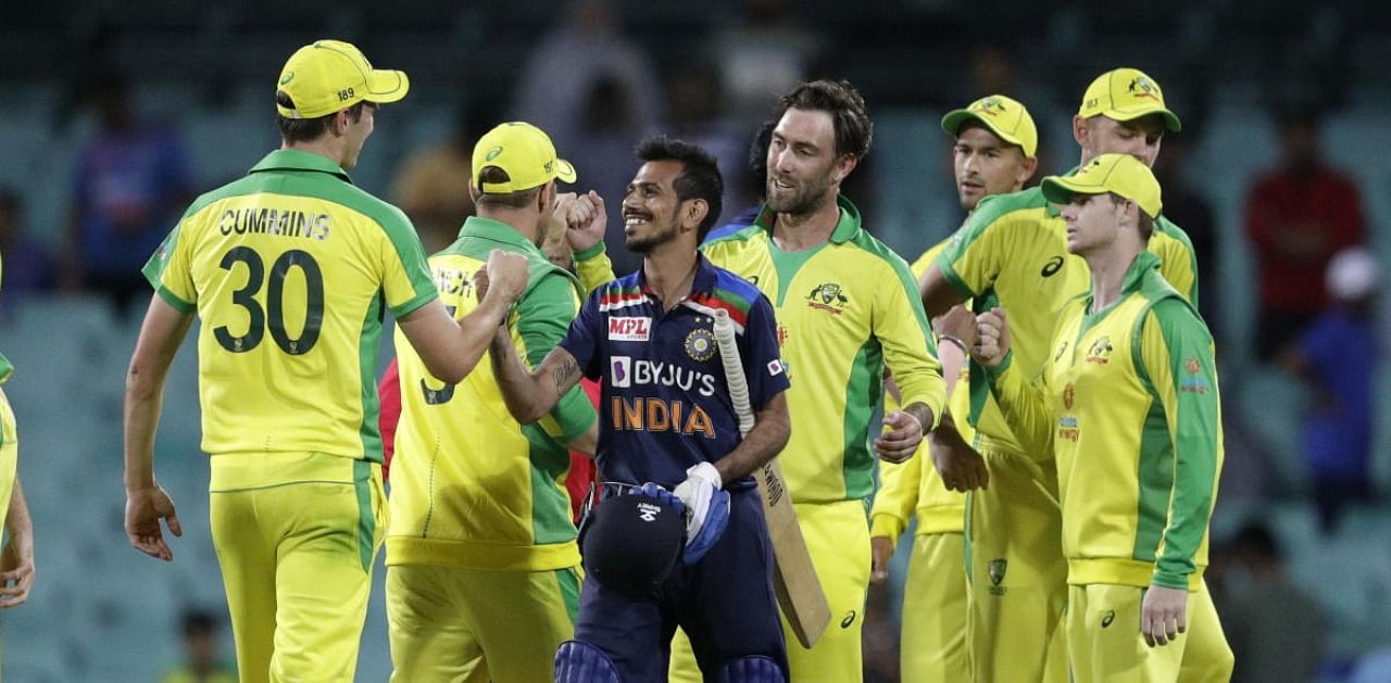 India's Yuzendra Chahal gestures with -Australia's Pat Cummins, left, following the one day international cricket match between India and Australia at the Sydney Cricket Ground in Sydney, Australia, Sunday, Nov. 29, 2020. Credit: AP/PTI Photo
