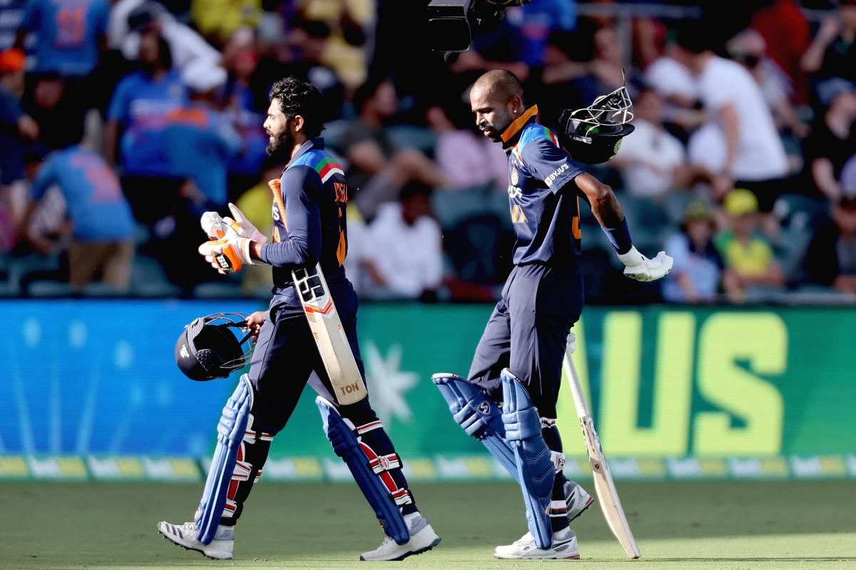 India's batsmen Hardik Pandya (R) and Ravindra Jadeja walk back to the pavilion at the end of 50 overs during the third one-day international cricket match between Australia and India at Manuka Oval in Canberra on December 2, 2020. Credit: AFP photo. 