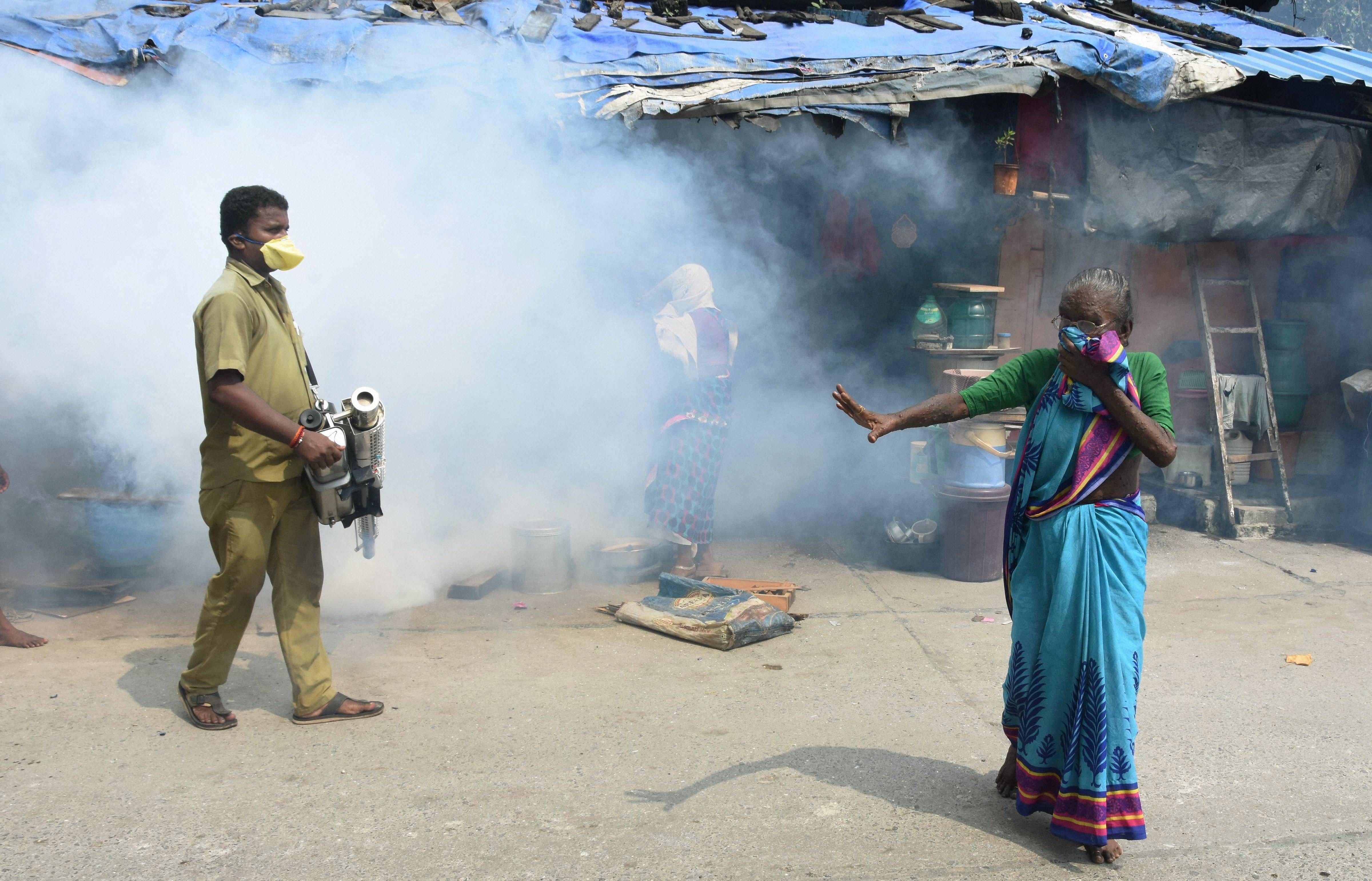 A BMC worker carries out fumigation works as part of preventive measures against malaria. Credit: PTI Photo
