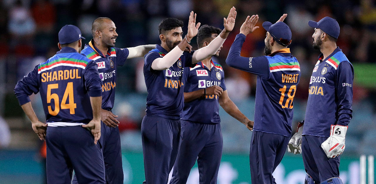 India's Jasprit Bumrah, third left, is congratulated by teammates after bowling Australia's Glenn Maxwell during their one day international cricket match at Manuka Oval in Canberra, Australia. Credit: AP Photo