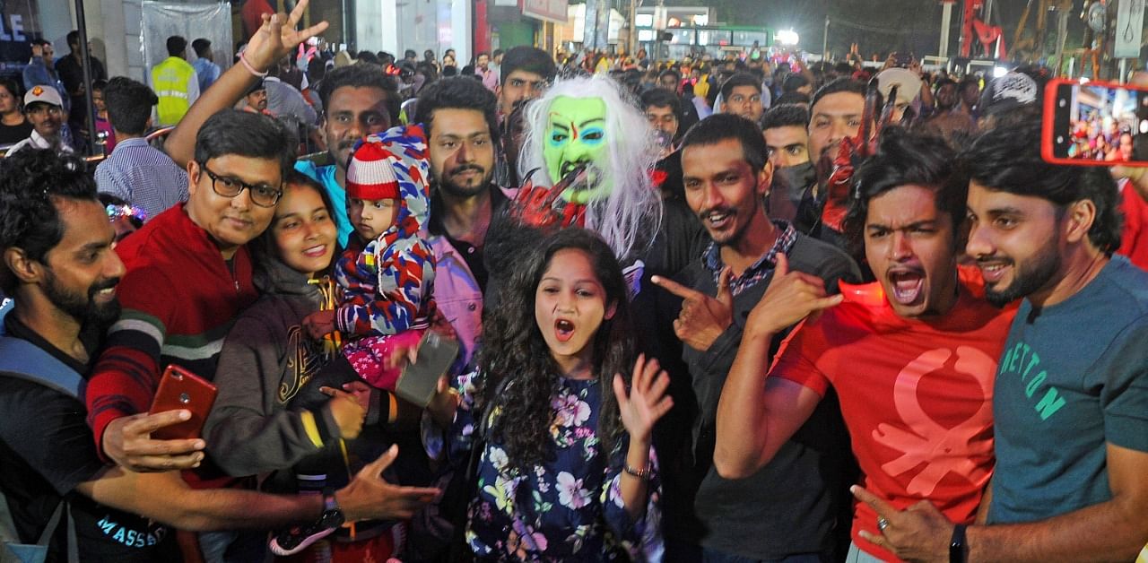 People celebrate on the New Year’s Eve on Brigade Road in Bengaluru. Credit: DH File Photo