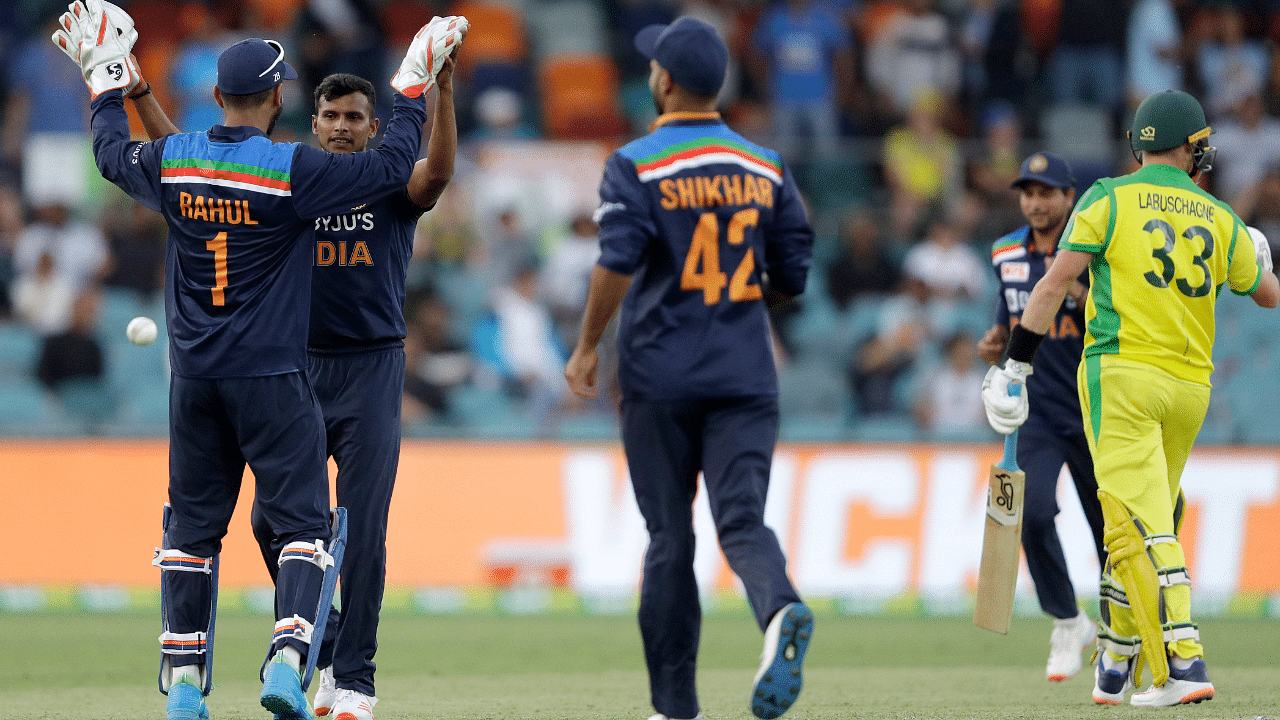 India's Thangarasu Natarajan, second left, is congratulated by teammate India's K.L. Rahul after bowling Australia's Marnus I nLabuschagne. Credit: AP Photo