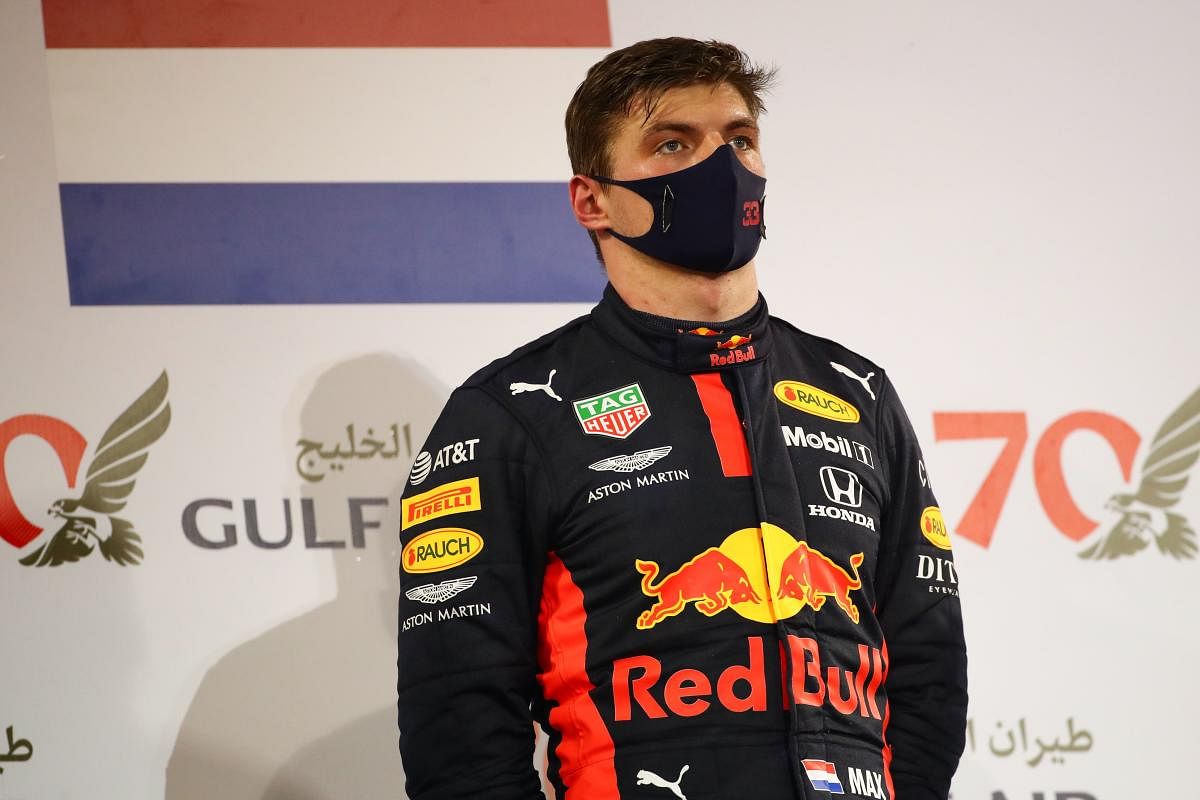 Red Bull's Dutch driver Max Verstappen listens to the national anthem on the podium after the Bahrain Formula One Grand Prix at the Bahrain International Circuit in the city of Sakhir on November 29, 2020. Credit: AFP photo. 