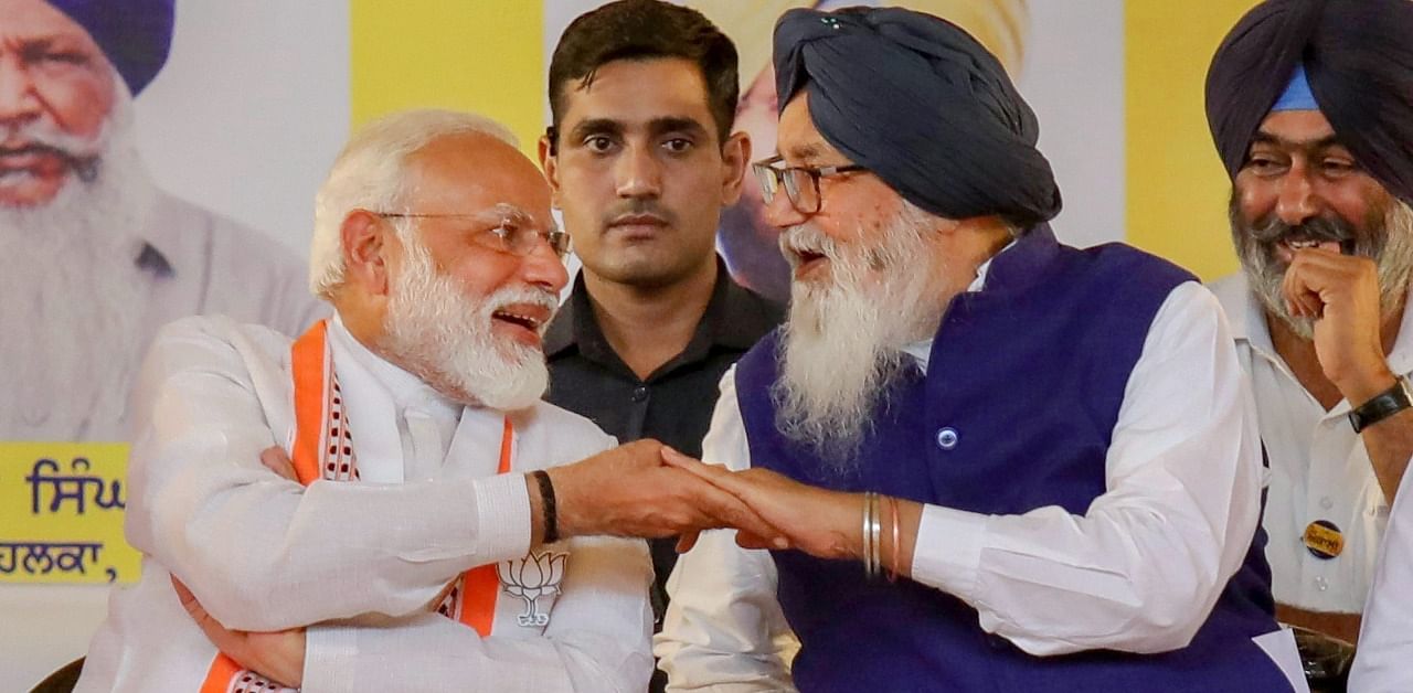 In this May 13, 2019 file photo, Prime Minister Narendra Modi shares a light moment with Shiromani Akali Dal (SAD) patron and former chief minister of Punjab Parkash Singh Badal, during an election campaign rally for the ongoing Lok Sabha polls, at Bathinda. Credit: PTI Photo